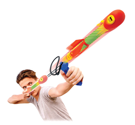 Person holding a colorful toy sling shot rocket toy on a white background